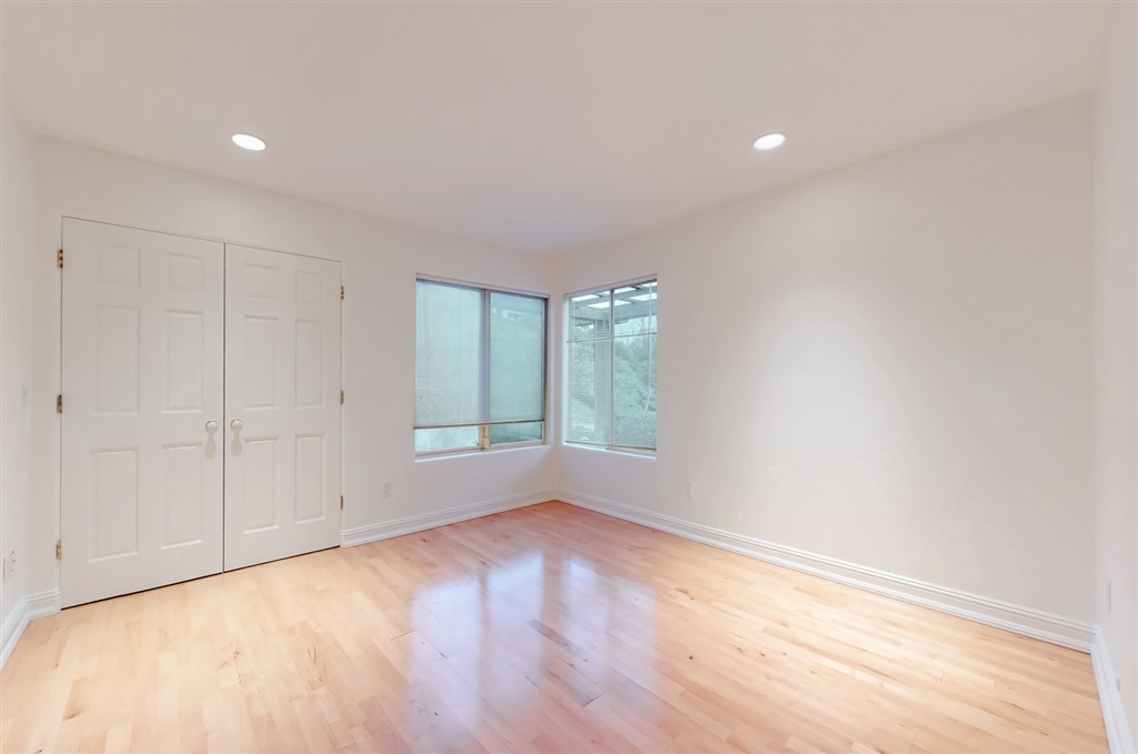 12211 Bajada Road San Diego, CA 92128 - Photo 15 of 23 a view of empty room with wooden floor and fan