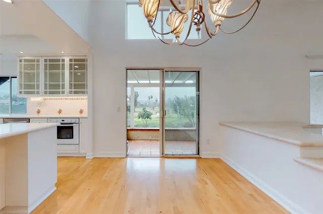 a view of a kitchen with wooden floor and a sink