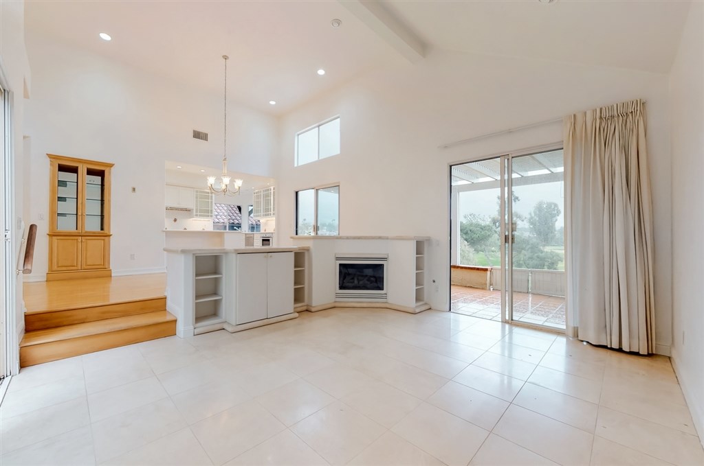 12211 Bajada Road San Diego, CA 92128 - Photo 5 of 23 a view of a kitchen with furniture and a fireplace
