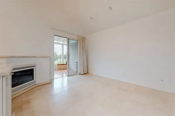 a view of a kitchen with a sink and a fireplace