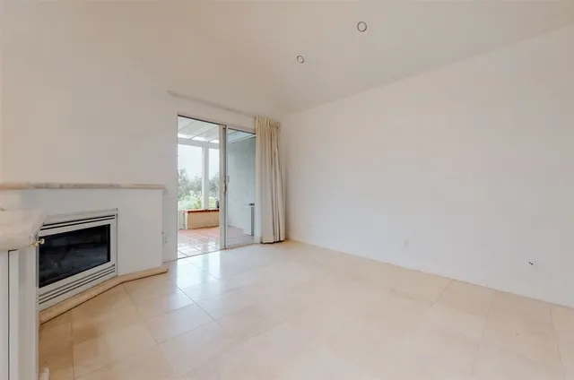 a view of a kitchen with a sink and a fireplace