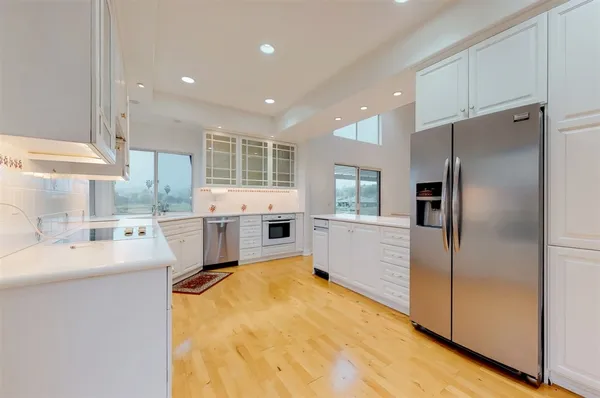 a kitchen with a stove a sink and a refrigerator