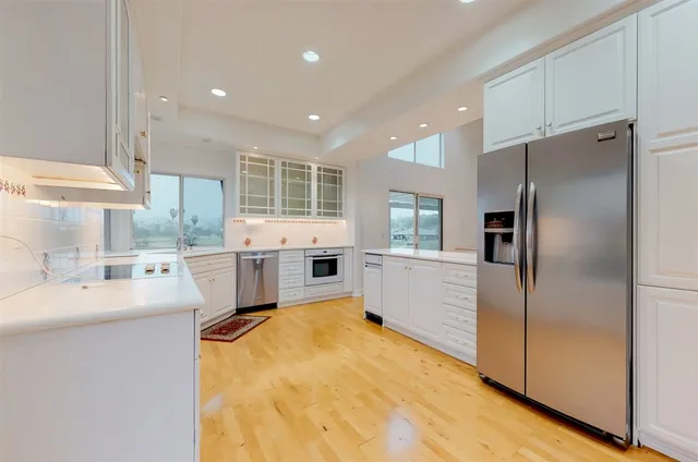 a kitchen with a stove a sink and a refrigerator