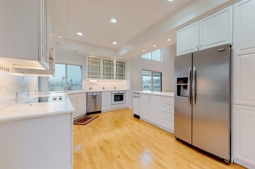12211 Bajada Road San Diego, CA 92128 - Photo 8 of 23 a kitchen with a sink stainless steel appliances and counter space