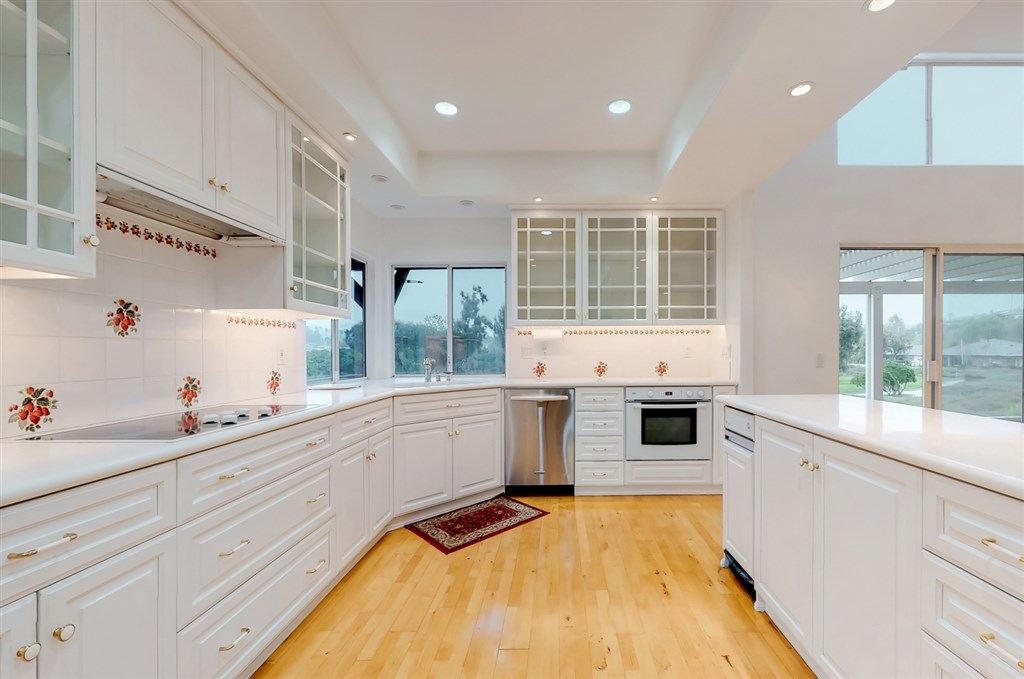 12211 Bajada Road San Diego, CA 92128 - Photo 9 of 23 a kitchen with a stove a sink and a refrigerator