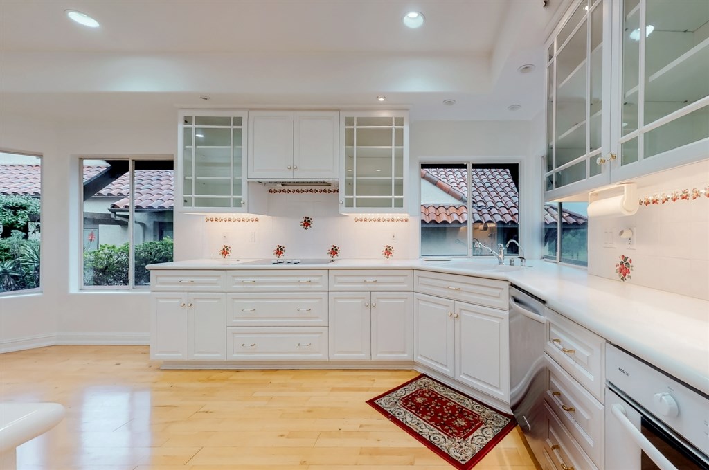 12211 Bajada Road San Diego, CA 92128 - Photo 10 of 23 a kitchen with a sink and cabinets