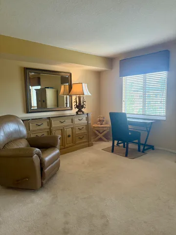 a bedroom with furniture and a flat screen tv