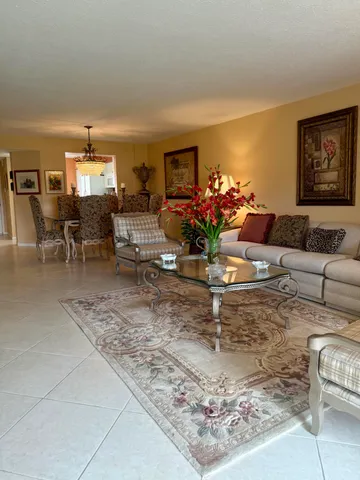 a living room with furniture and a dining table