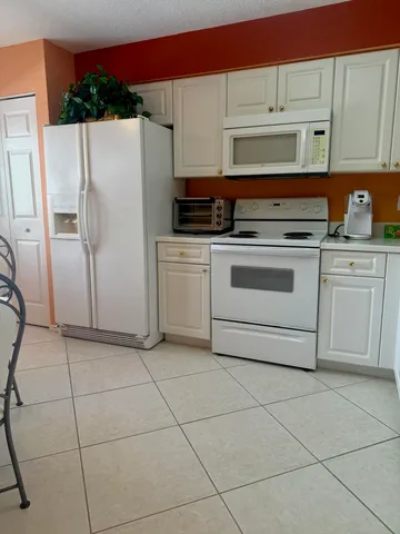 a kitchen with stainless steel appliances a refrigerator and a stove top oven