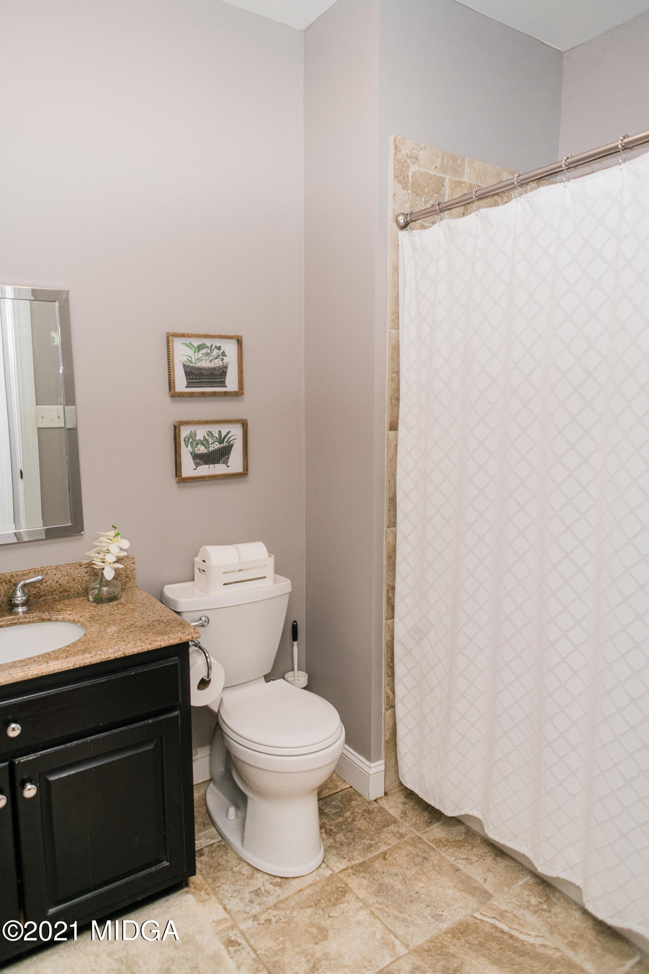 4418 Jones Road Macon, GA 31216 - Photo 14 of 50 a white toilet sitting next to a bathroom sink