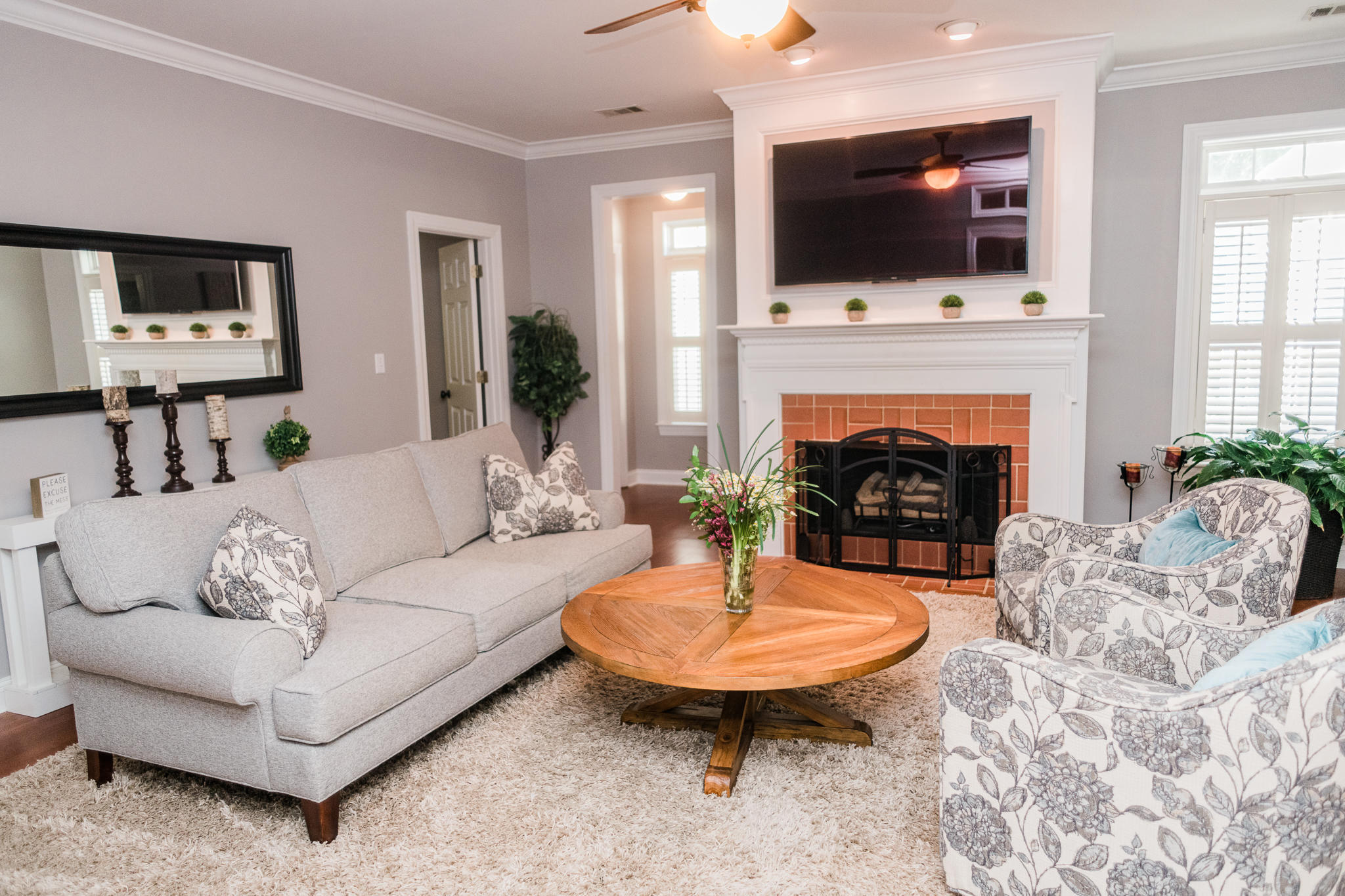 4418 Jones Road Macon, GA 31216 - Photo 40 of 50 a living room with furniture a flat screen tv and a fireplace