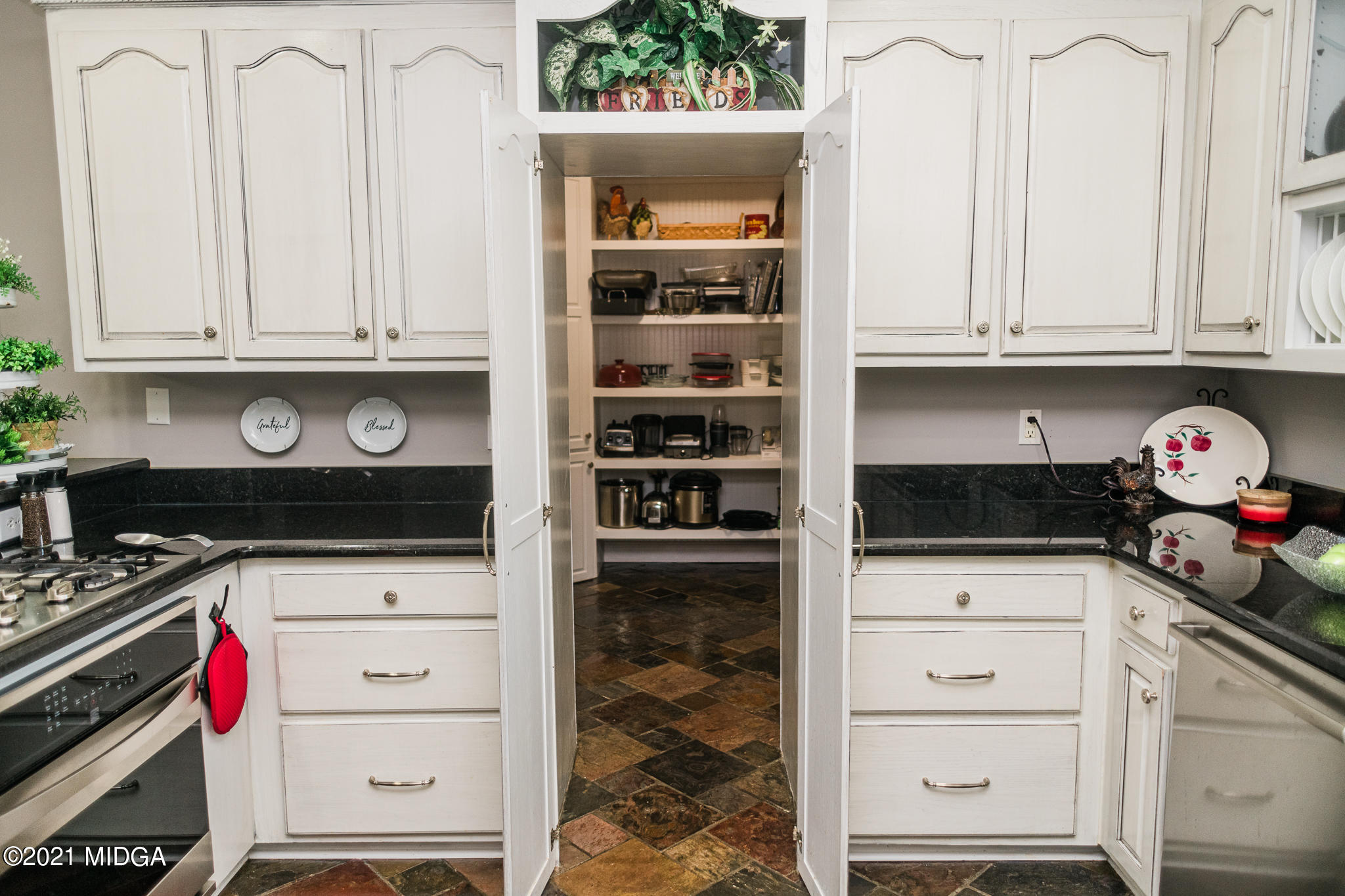 4418 Jones Road Macon, GA 31216 - Photo 8 of 50 a kitchen with white cabinets and appliances