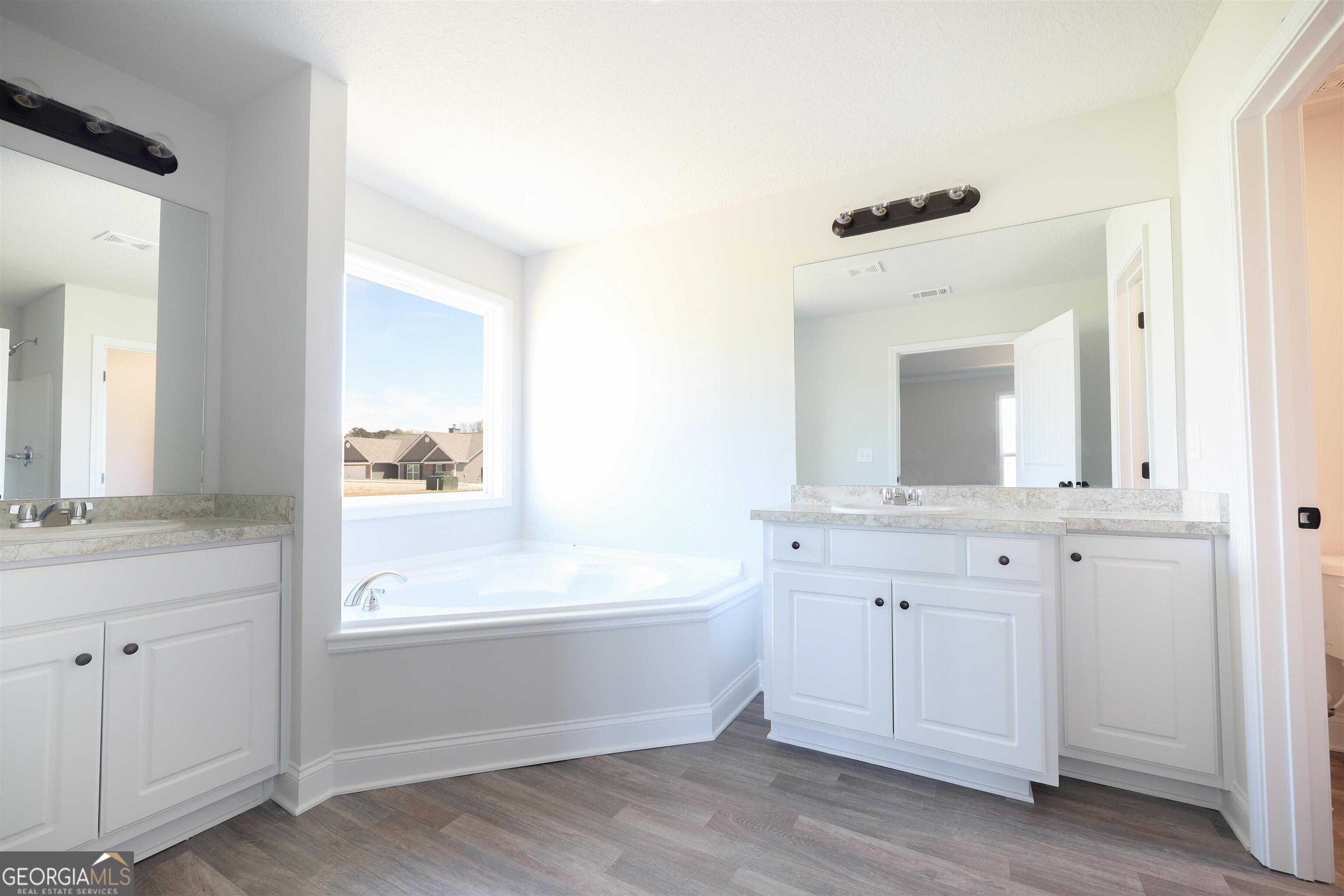 463 Tanners Bridge Road, Unit 2 Bethlehem, GA 30620 - Photo 5 of 6 a bathroom with a bathtub sink and mirror