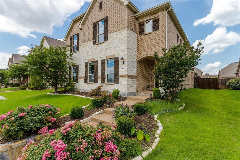 6333 Hall Road Frisco, TX 75034 - Photo 5 of 38 Brick and stone facade with dark shutters