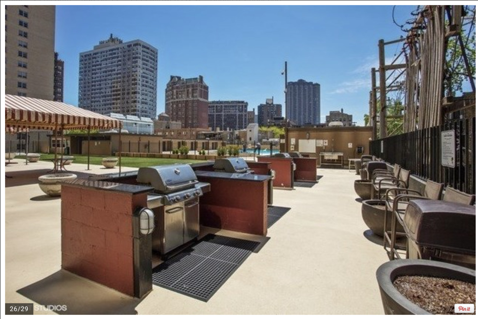655 West Irving Park Road, Unit 4009 Chicago, IL 60613 - Photo 22 of 27 a living room with furniture a city view and a potted plant