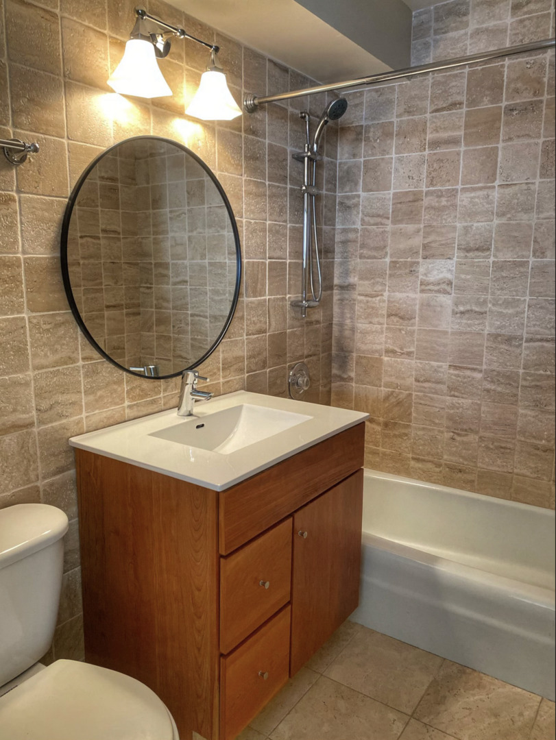 655 West Irving Park Road, Unit 4009 Chicago, IL 60613 - Photo 27 of 27 a bathroom with a sink toilet and a mirror