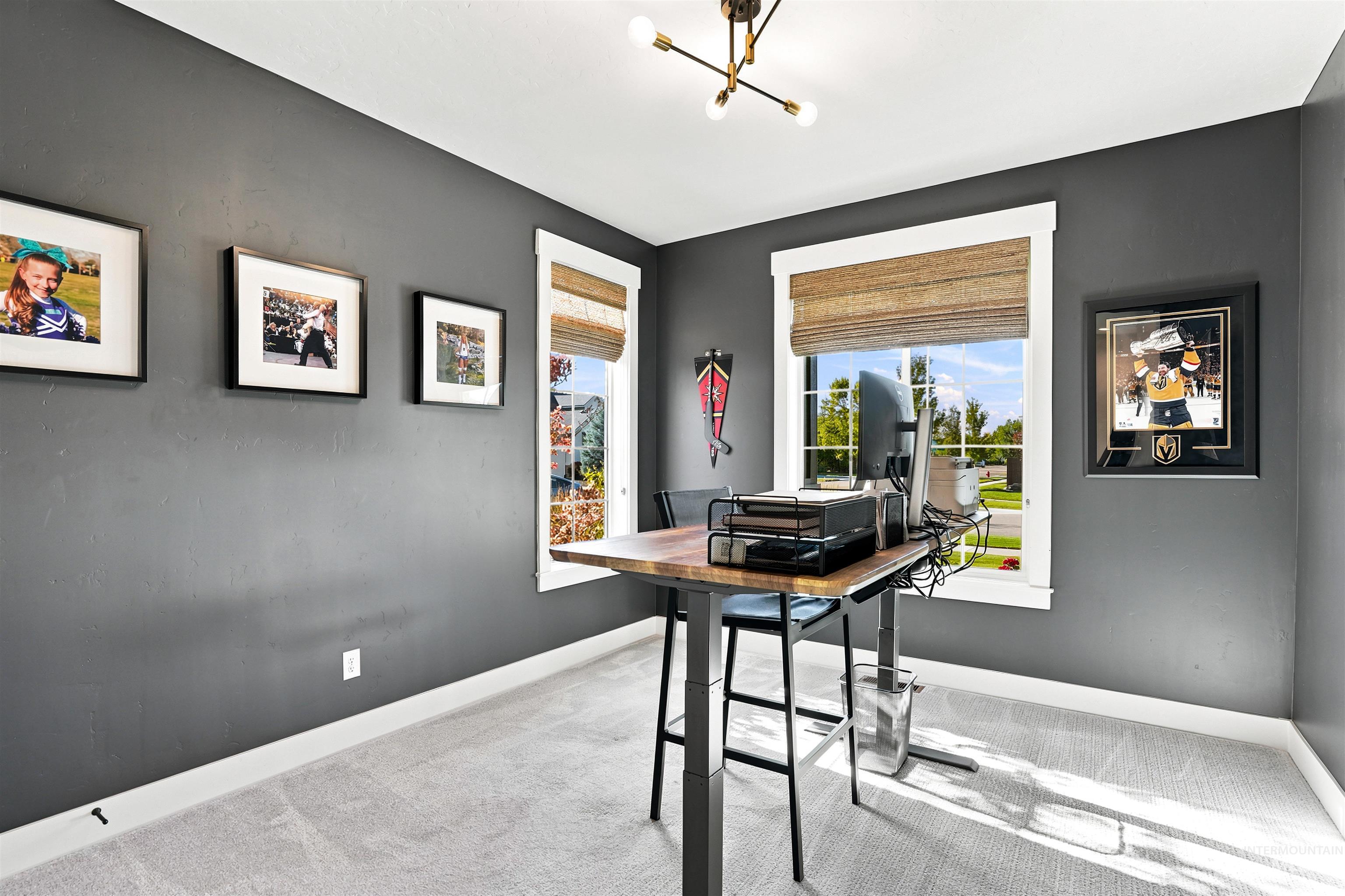 4323 West Ladle Rpds Drive Meridian, ID 83646 - Photo 35 of 49 Room featuring two large windows with woven blinds, neutral carpeting, and dark gray walls