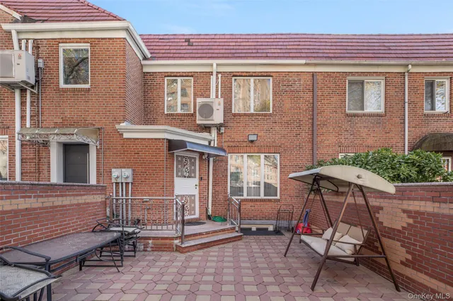 a view of a chair and tables in the patio