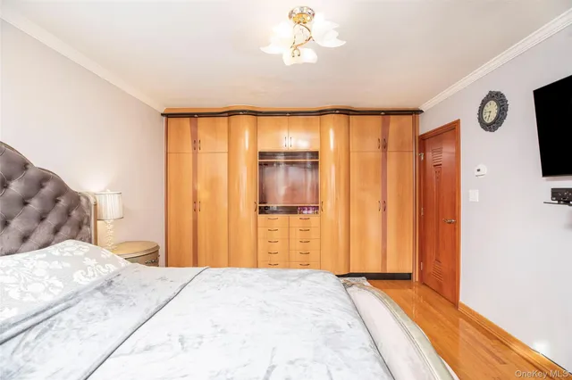 a bedroom with a bed and a chandelier