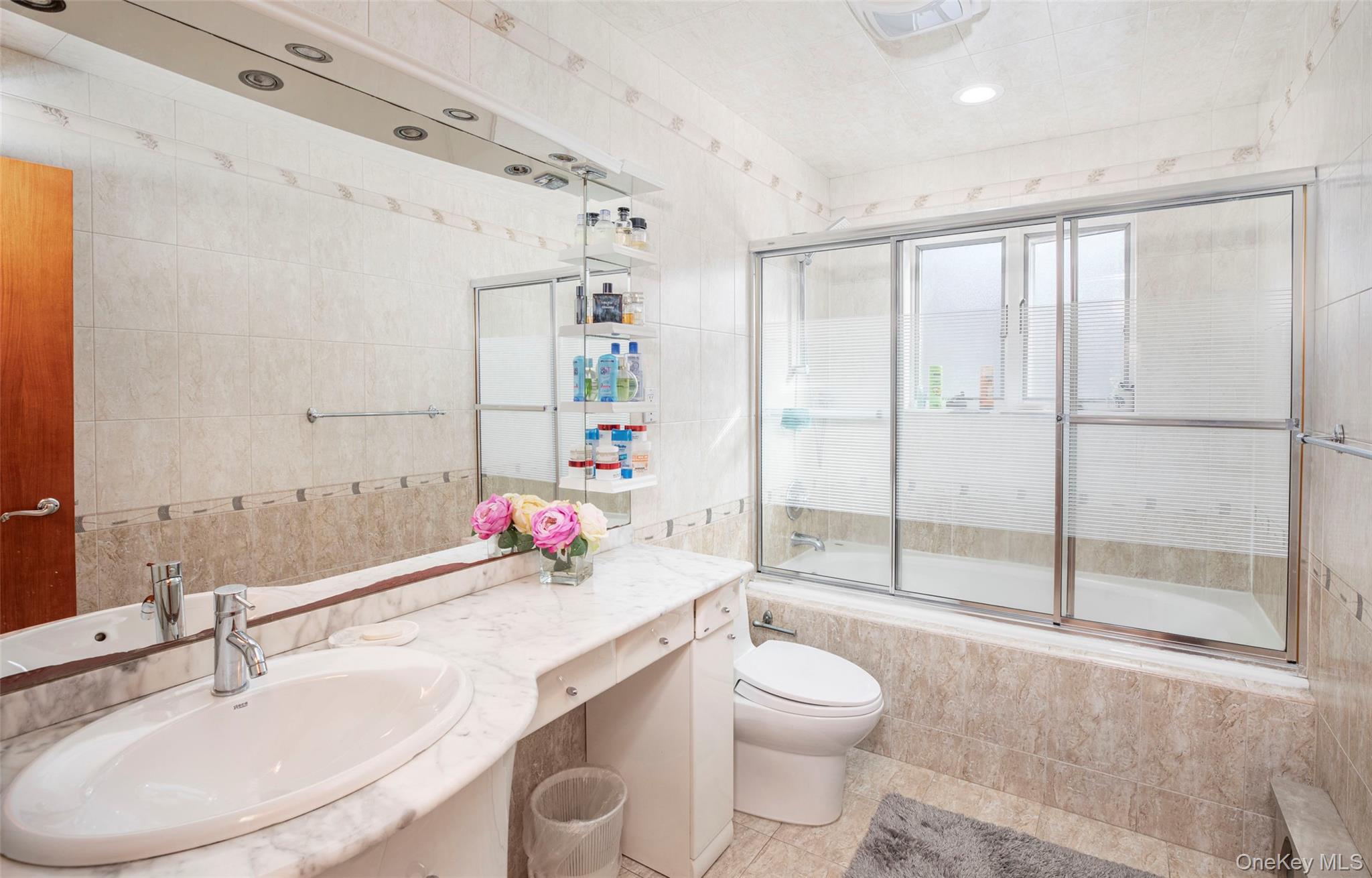 99-64 65th Avenue Queens, NY 11374 - Photo 12 of 22 a bathroom with a sink toilet vanity and shower