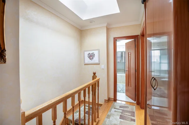 a view of a hallway with wooden floor and door