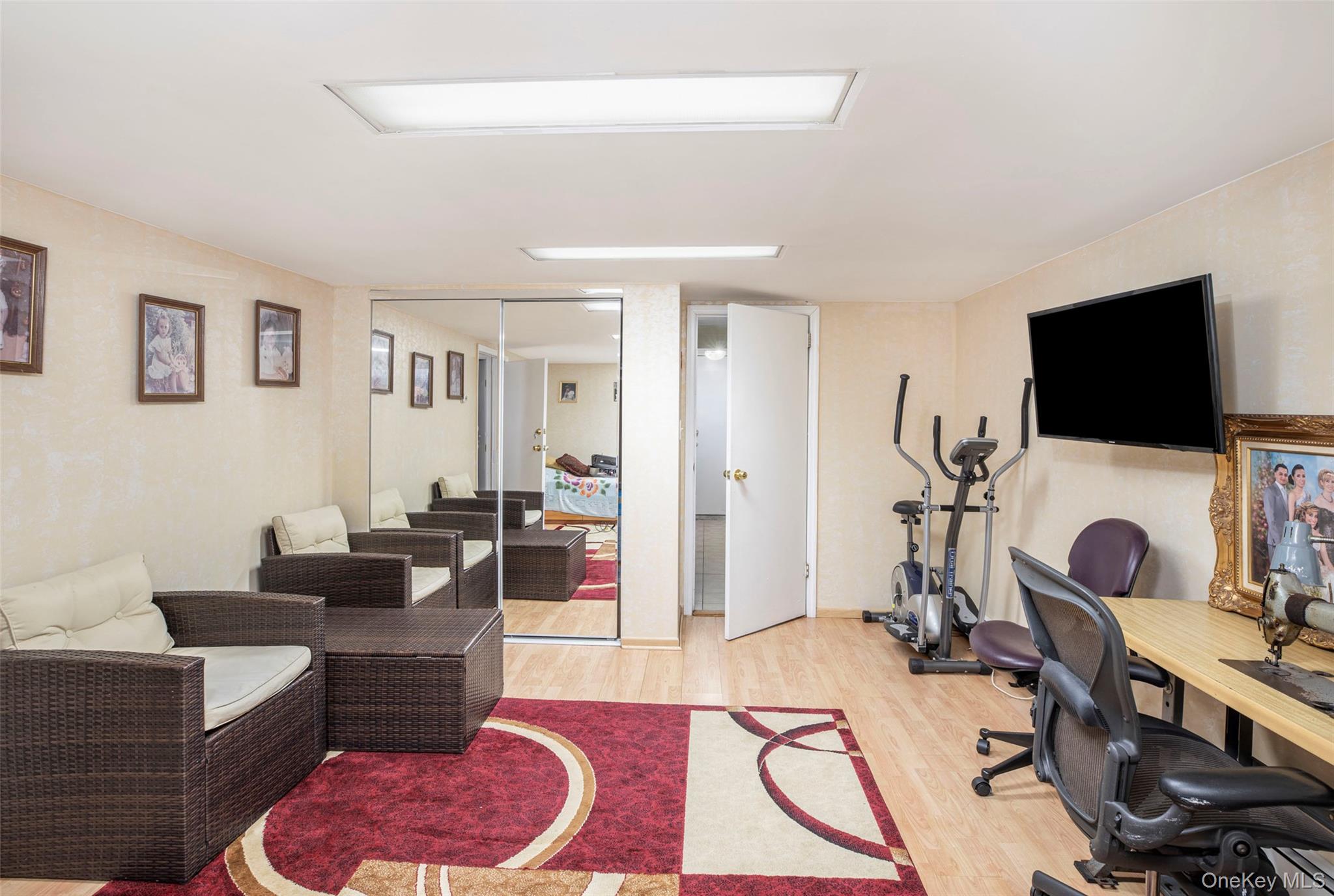 99-64 65th Avenue Queens, NY 11374 - Photo 16 of 22 a living room with furniture and a flat screen tv