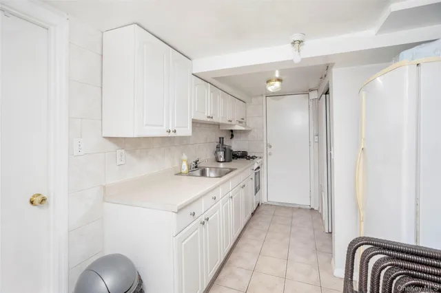 a kitchen with a sink cabinets and window