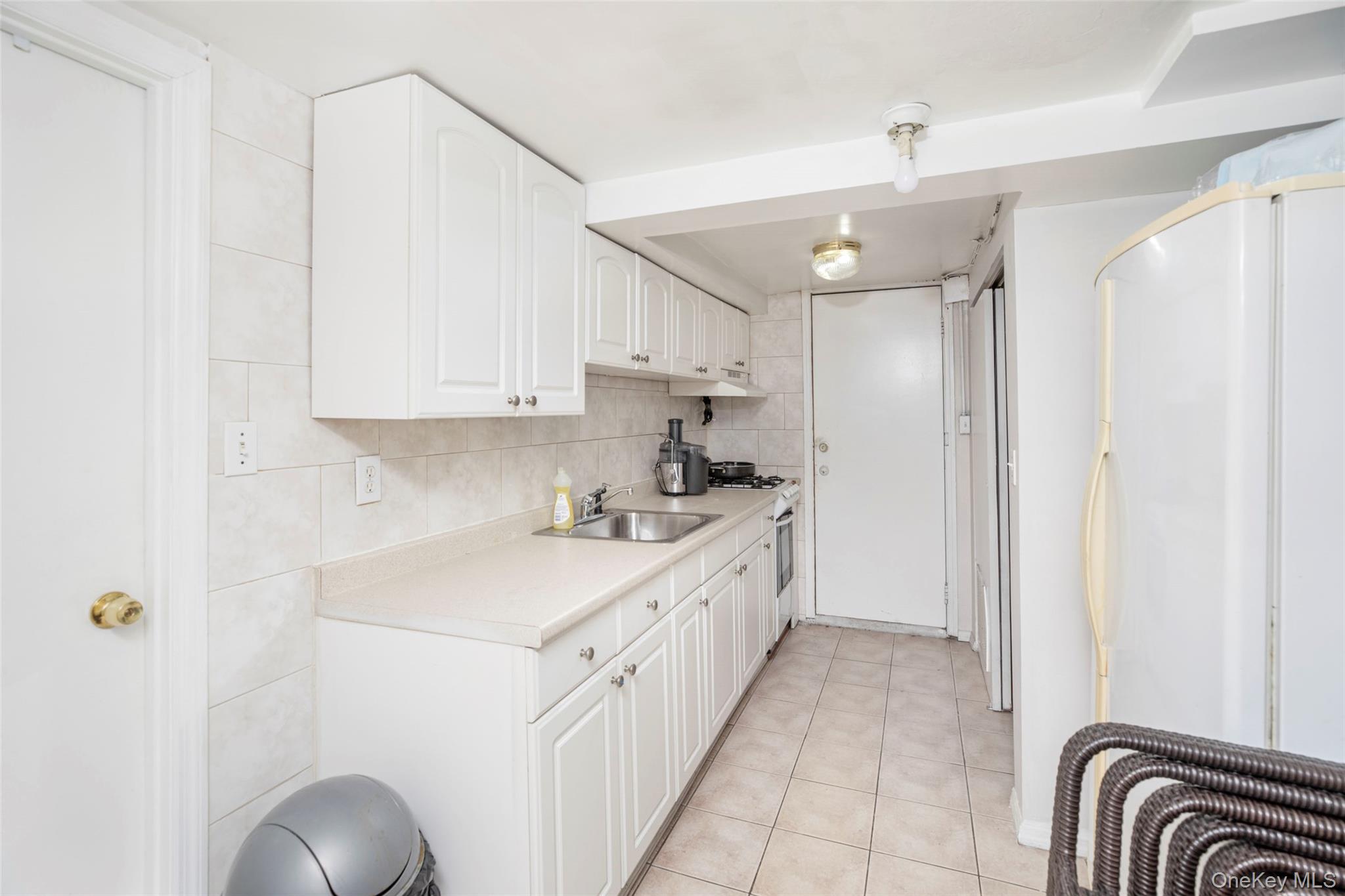 99-64 65th Avenue Queens, NY 11374 - Photo 17 of 22 a kitchen with a sink cabinets and window