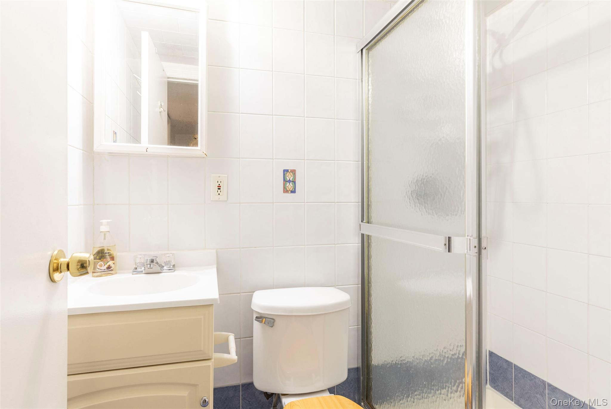 99-64 65th Avenue Queens, NY 11374 - Photo 18 of 22 a bathroom with a sink a toilet and a mirror