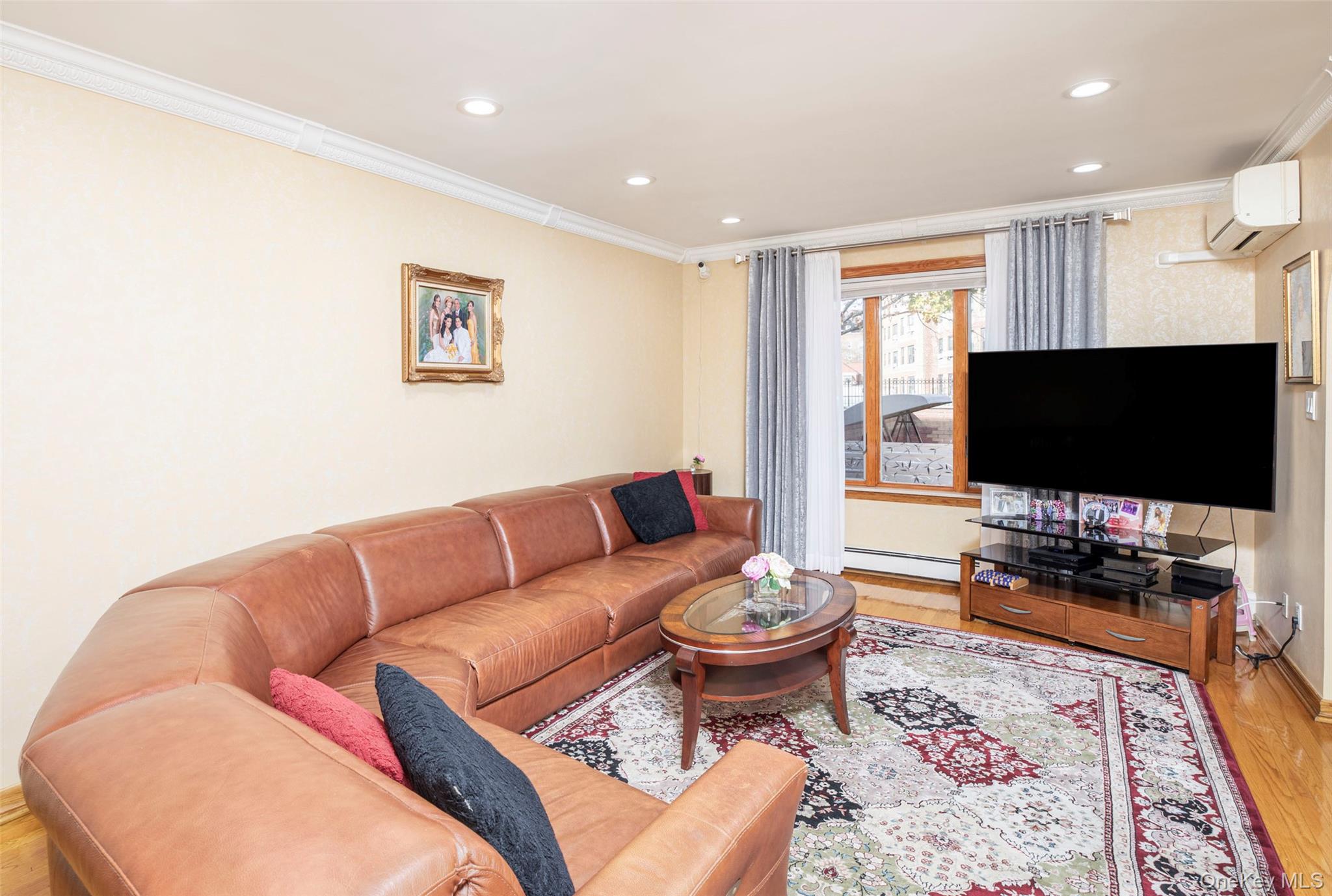99-64 65th Avenue Queens, NY 11374 - Photo 3 of 22 a living room with furniture and a flat screen tv