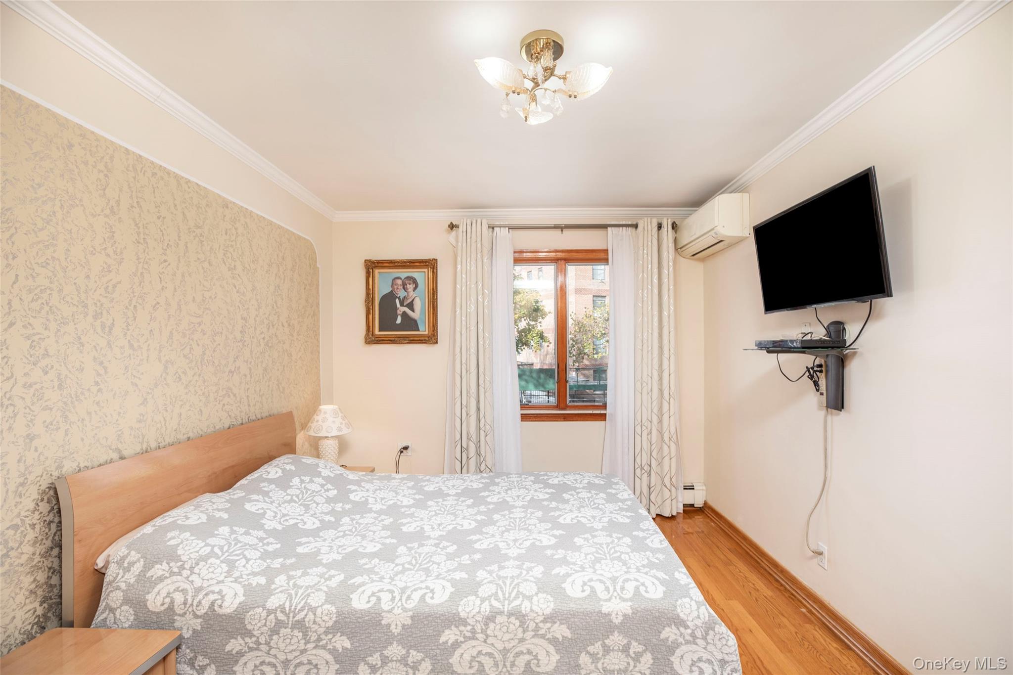 99-64 65th Avenue Queens, NY 11374 - Photo 8 of 22 a bedroom with a bed and a flat screen tv