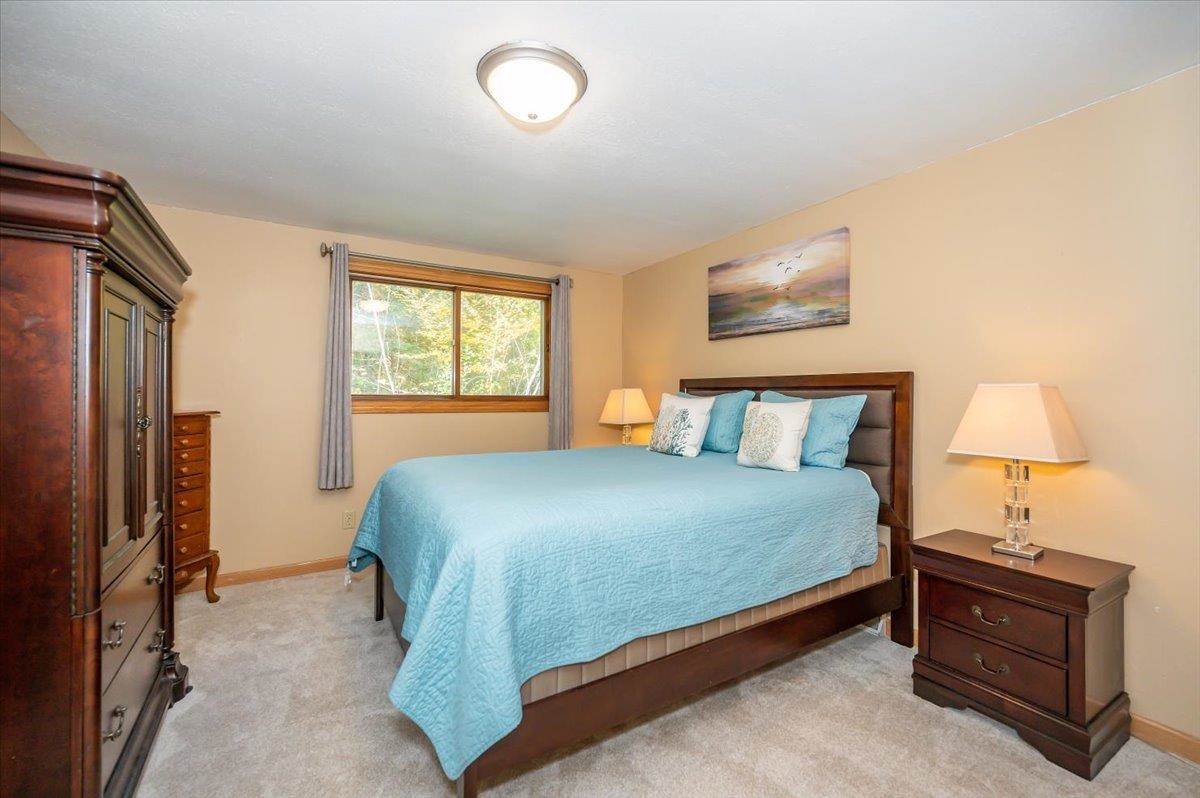 6891 South Oakland Road Superior, WI 54880 - Photo 15 of 29 Bedroom with light carpet and baseboards