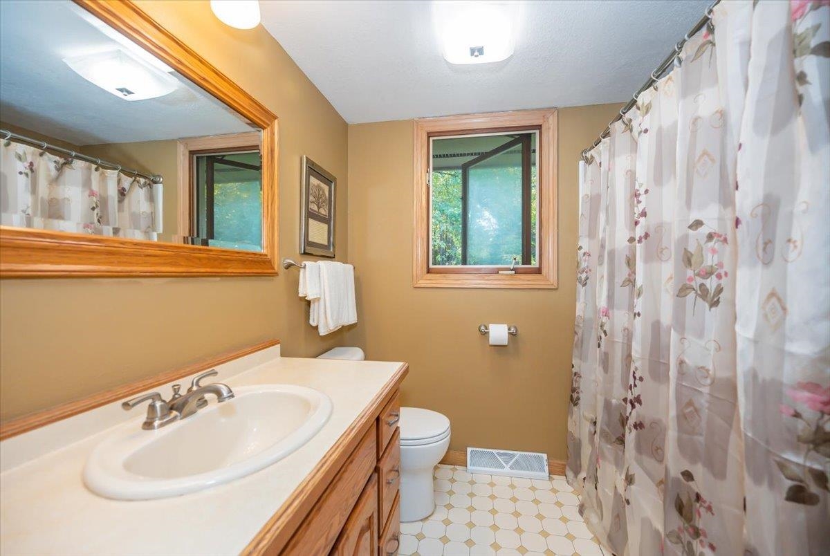 6891 South Oakland Road Superior, WI 54880 - Photo 16 of 29 Full bathroom featuring vanity and a shower with shower curtain