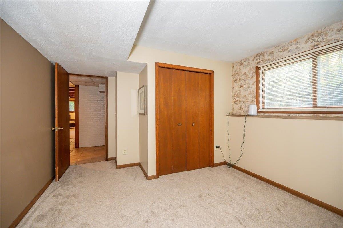 6891 South Oakland Road Superior, WI 54880 - Photo 17 of 29 Unfurnished bedroom featuring a textured ceiling, a closet, and carpet flooring