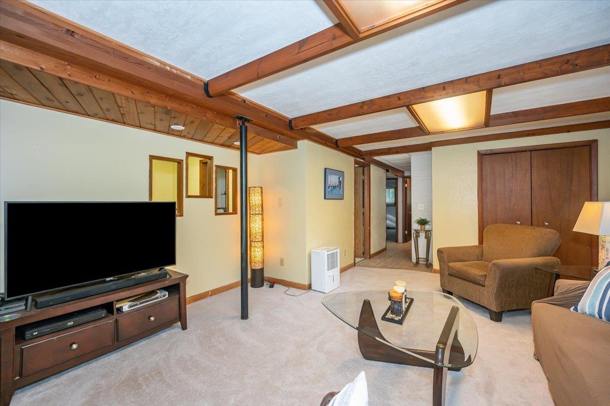6891 South Oakland Road Superior, WI 54880 - Photo 19 of 29 Living area featuring beamed ceiling and carpet