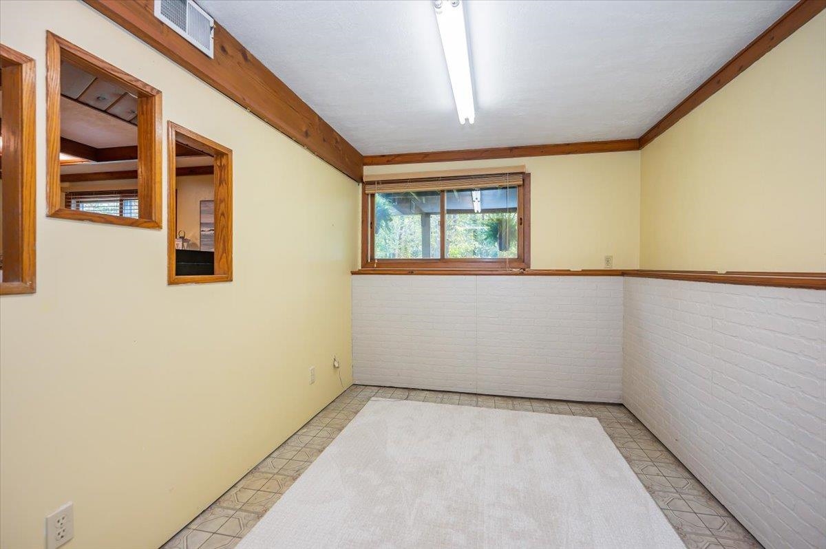 6891 South Oakland Road Superior, WI 54880 - Photo 22 of 29 Empty room featuring a wainscoted wall and crown molding