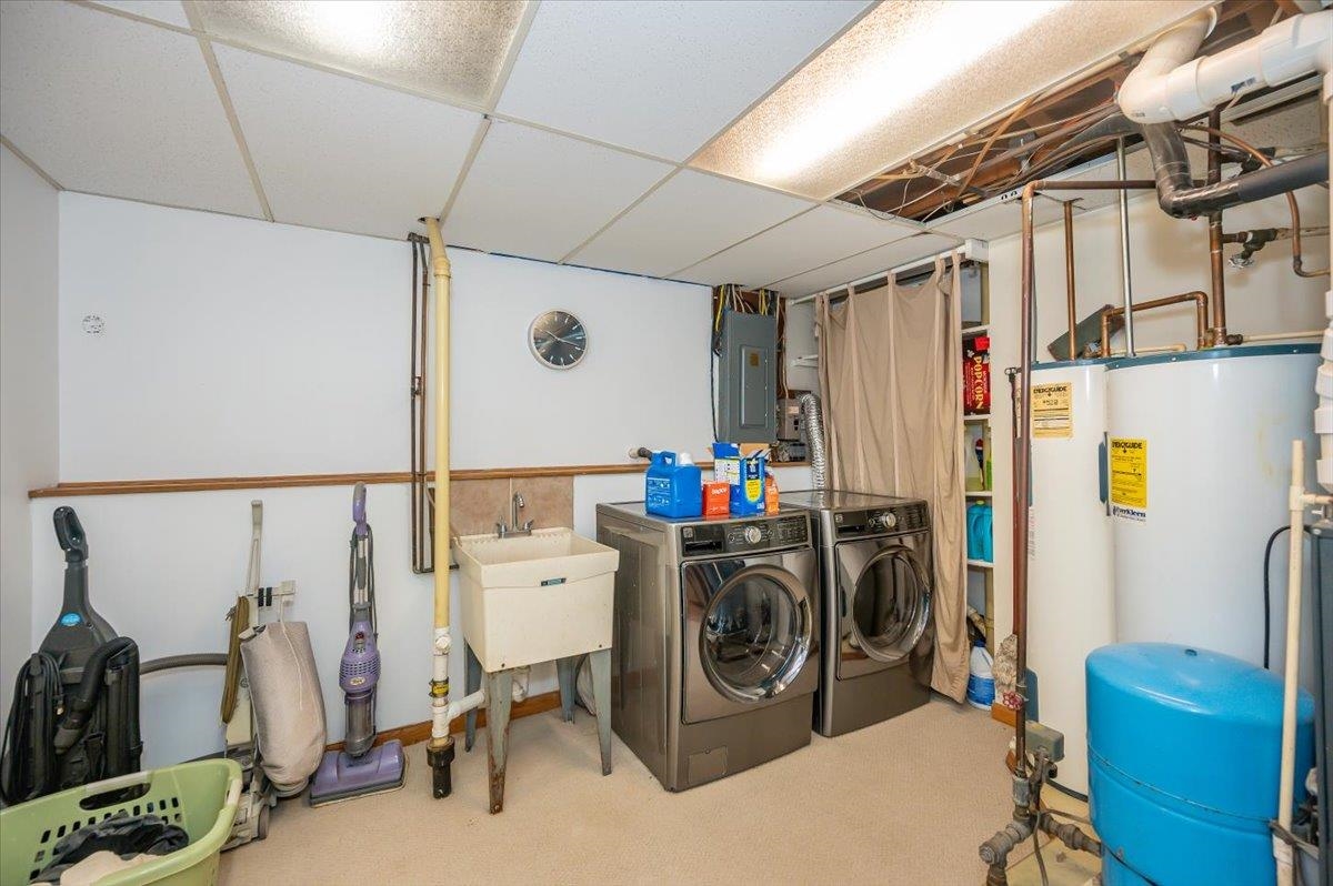 6891 South Oakland Road Superior, WI 54880 - Photo 23 of 29 Finished basement with a water pressure tank, carpet flooring, washer and dryer, electric panel, and a drop ceiling