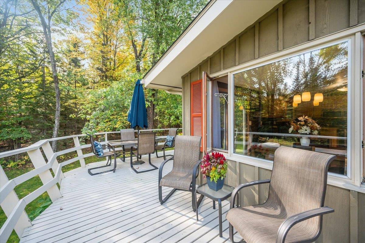6891 South Oakland Road Superior, WI 54880 - Photo 24 of 29 Wooden deck featuring outdoor dining space and view of wooded area