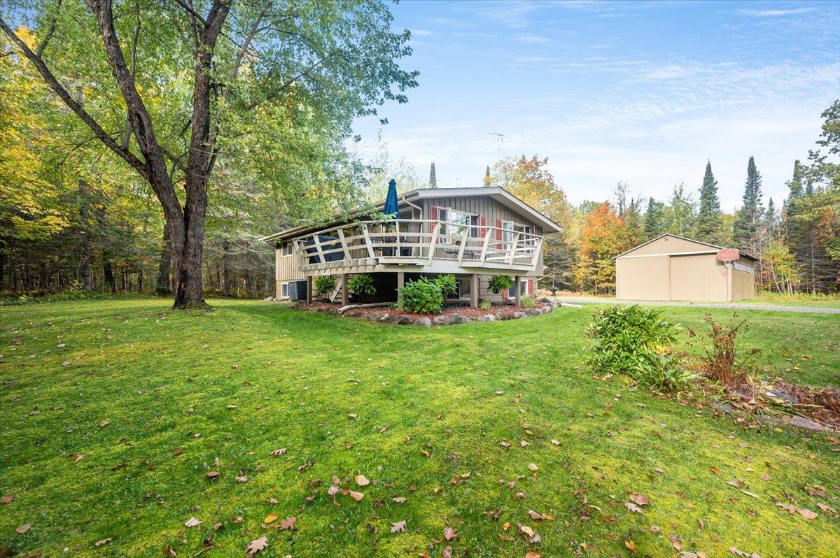 6891 South Oakland Road Superior, WI 54880 - Photo 25 of 29 Rear view of house featuring a wooden deck and a yard