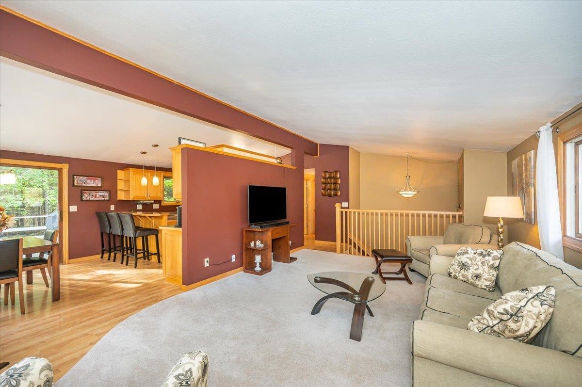 6891 South Oakland Road Superior, WI 54880 - Photo 3 of 29 Living area featuring plenty of natural light, beam ceiling, and light wood-style flooring