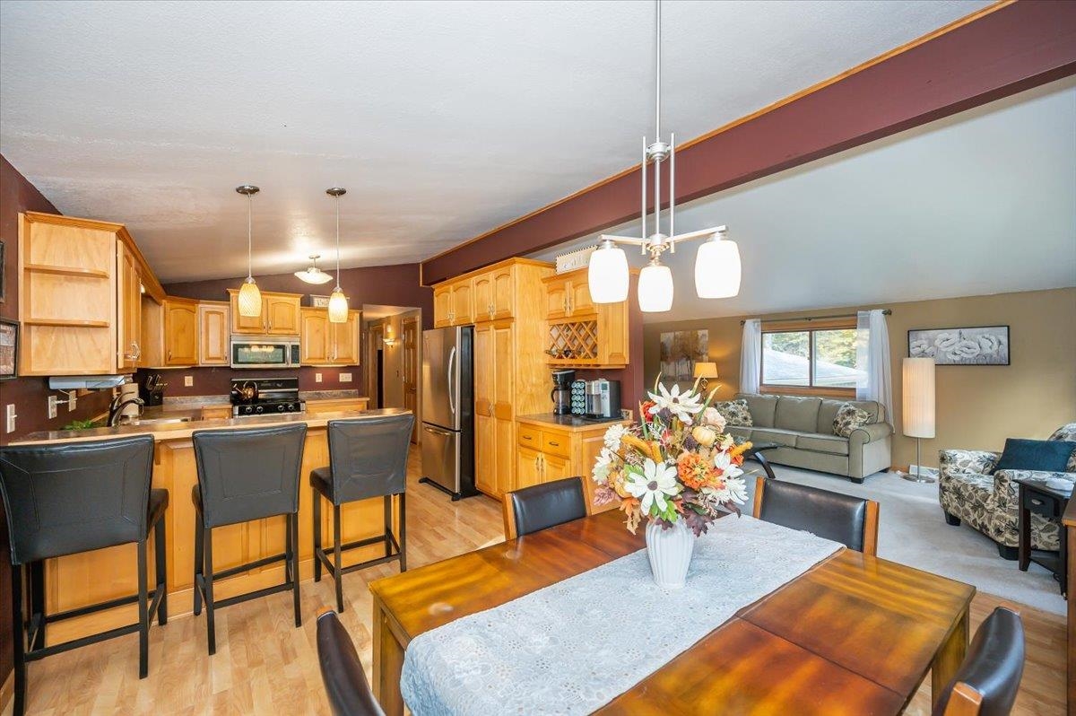 6891 South Oakland Road Superior, WI 54880 - Photo 5 of 29 Dining space with vaulted ceiling and light wood-style floors