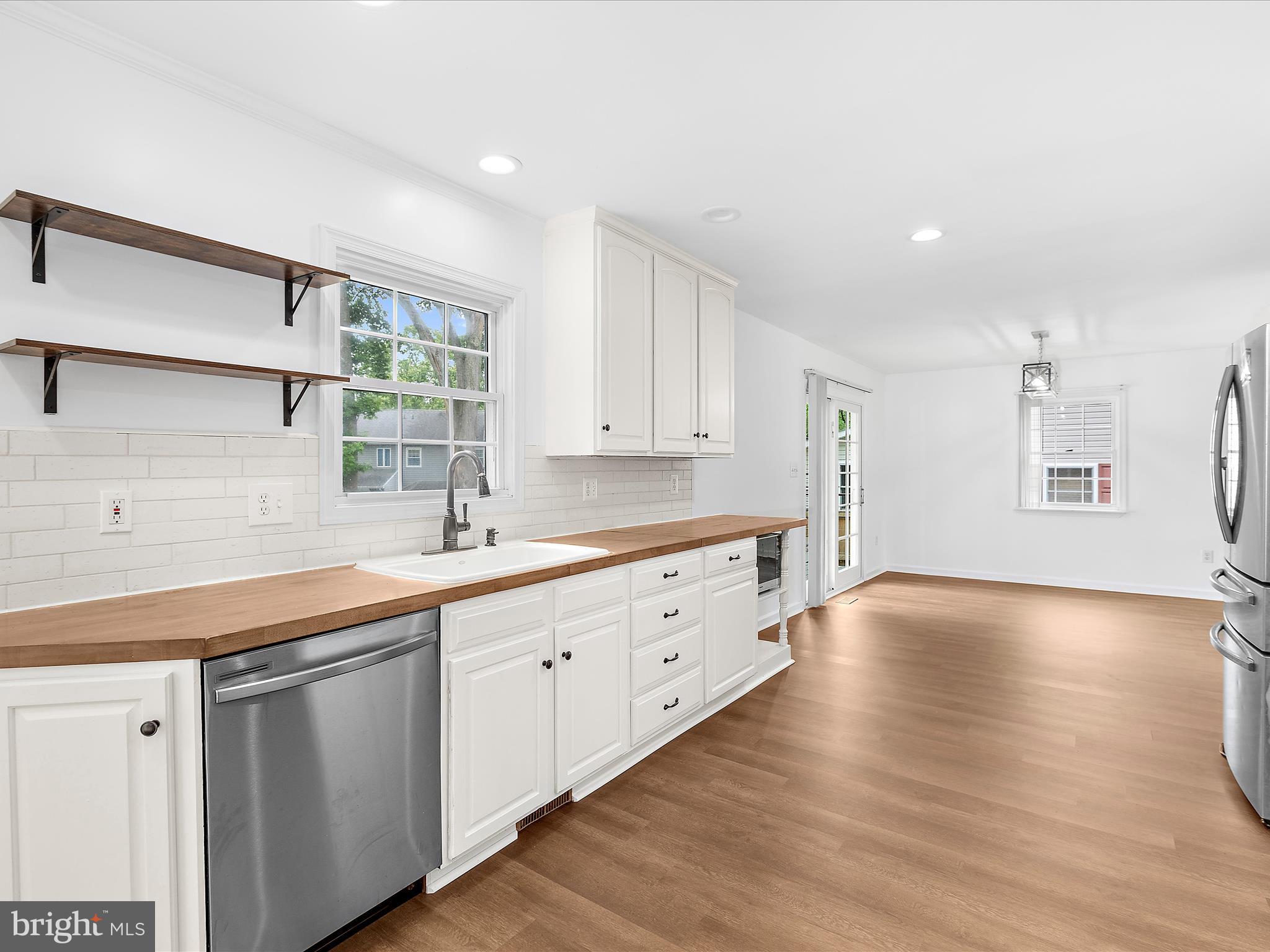 8475 Sexton Road Pasadena, MD 21122 - Photo 12 of 58 a kitchen with granite countertop white cabinets and a wooden floor