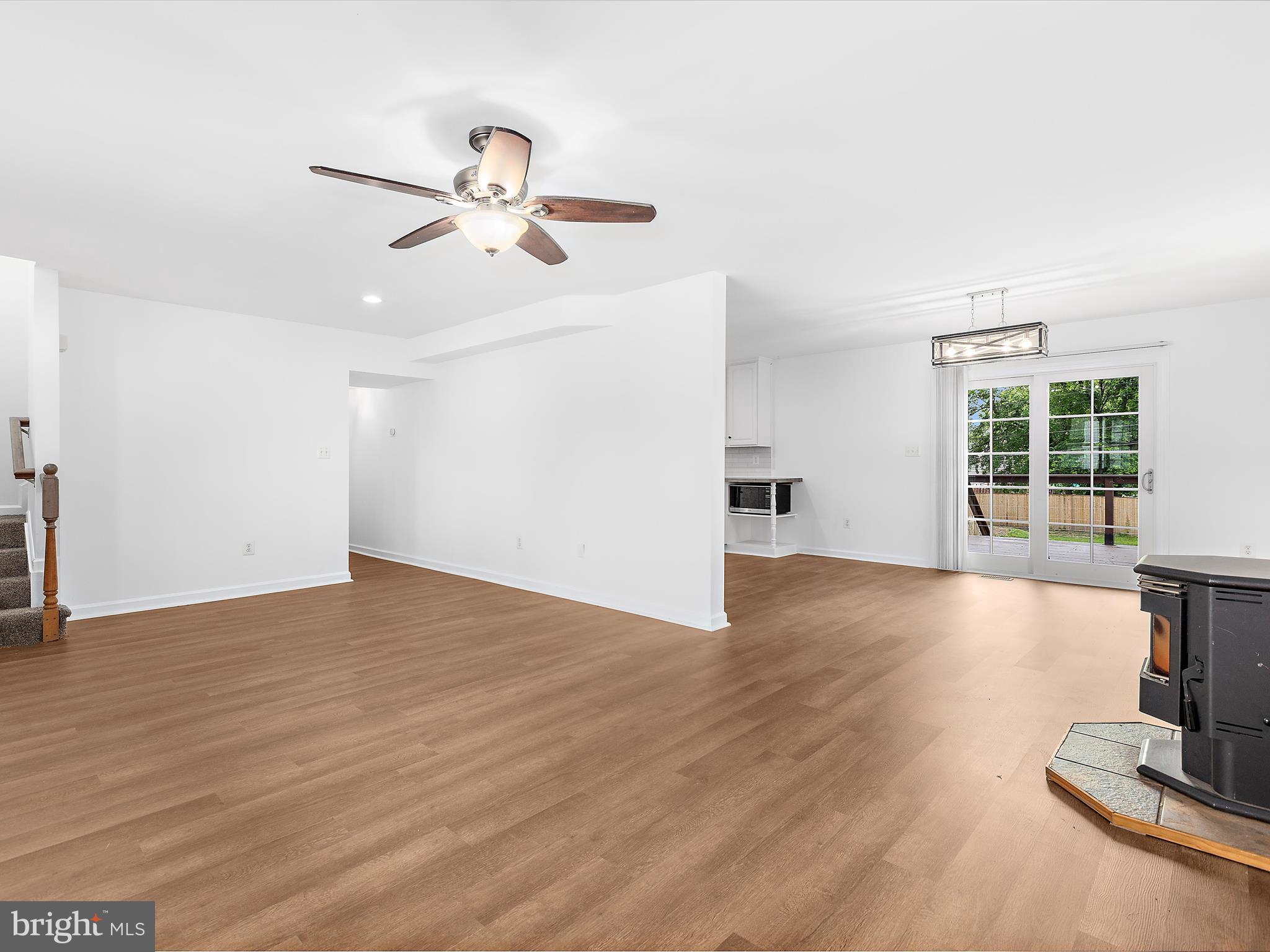 8475 Sexton Road Pasadena, MD 21122 - Photo 18 of 58 a view of empty room with wooden floor and fan