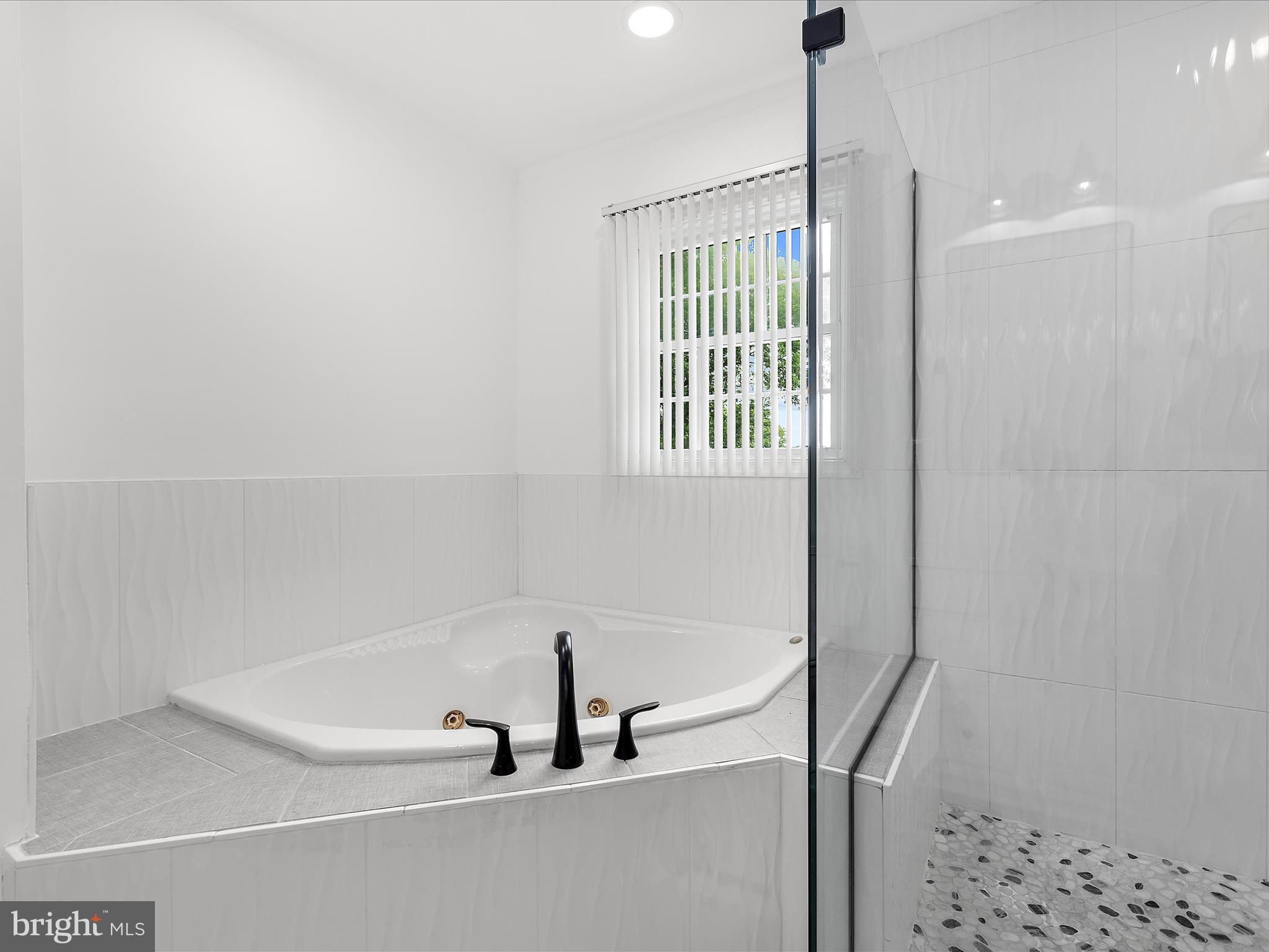 8475 Sexton Road Pasadena, MD 21122 - Photo 21 of 58 a bathroom with a bathtub and a window