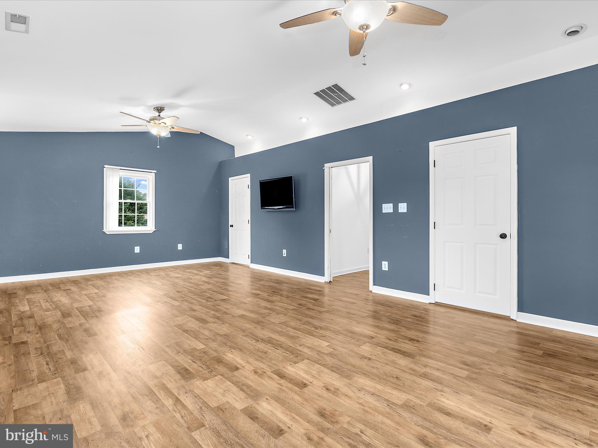 8475 Sexton Road Pasadena, MD 21122 - Photo 24 of 58 a view of an empty room with window and wooden floor