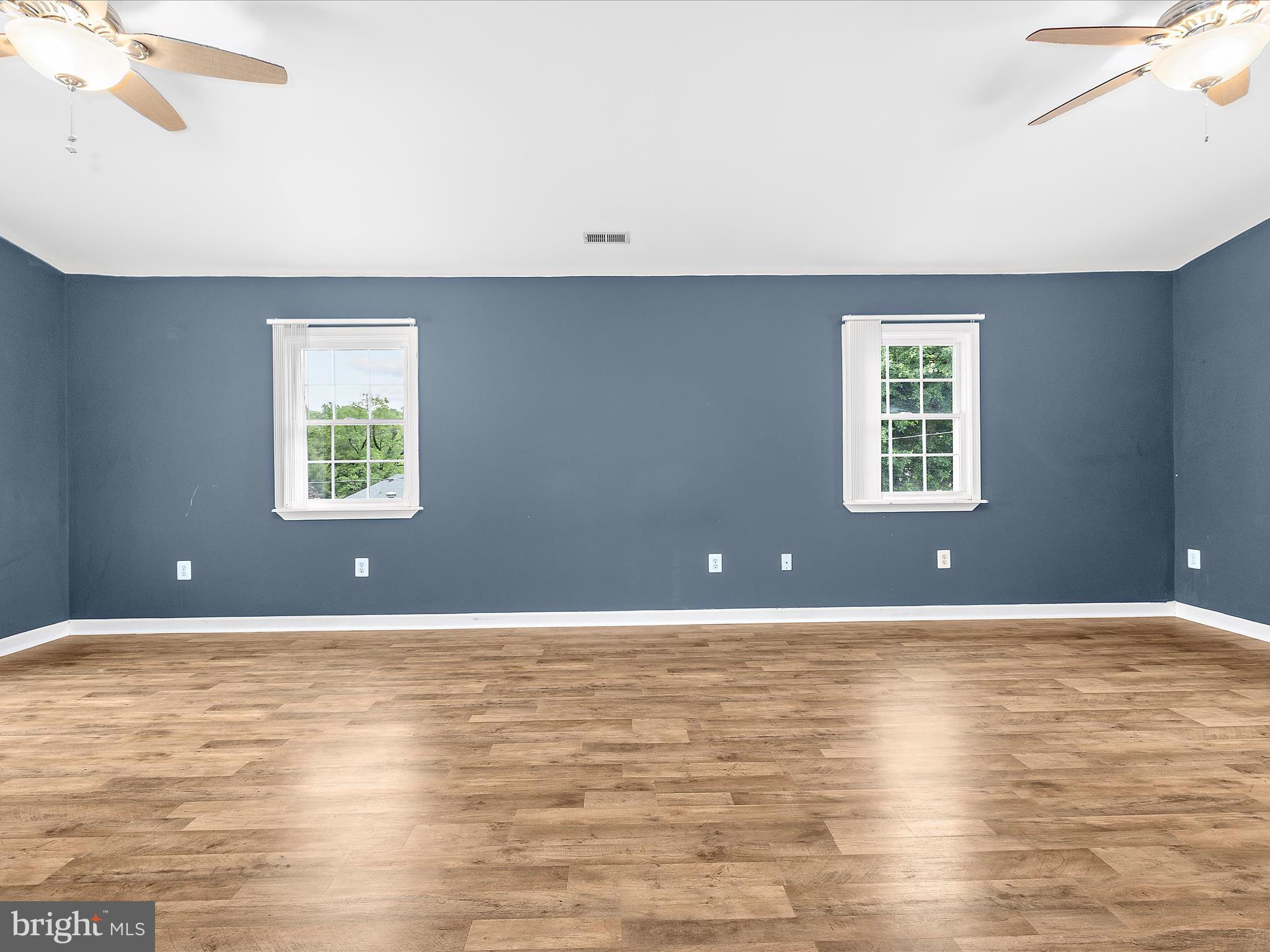 8475 Sexton Road Pasadena, MD 21122 - Photo 27 of 58 a view of an empty room with wooden floor and a window