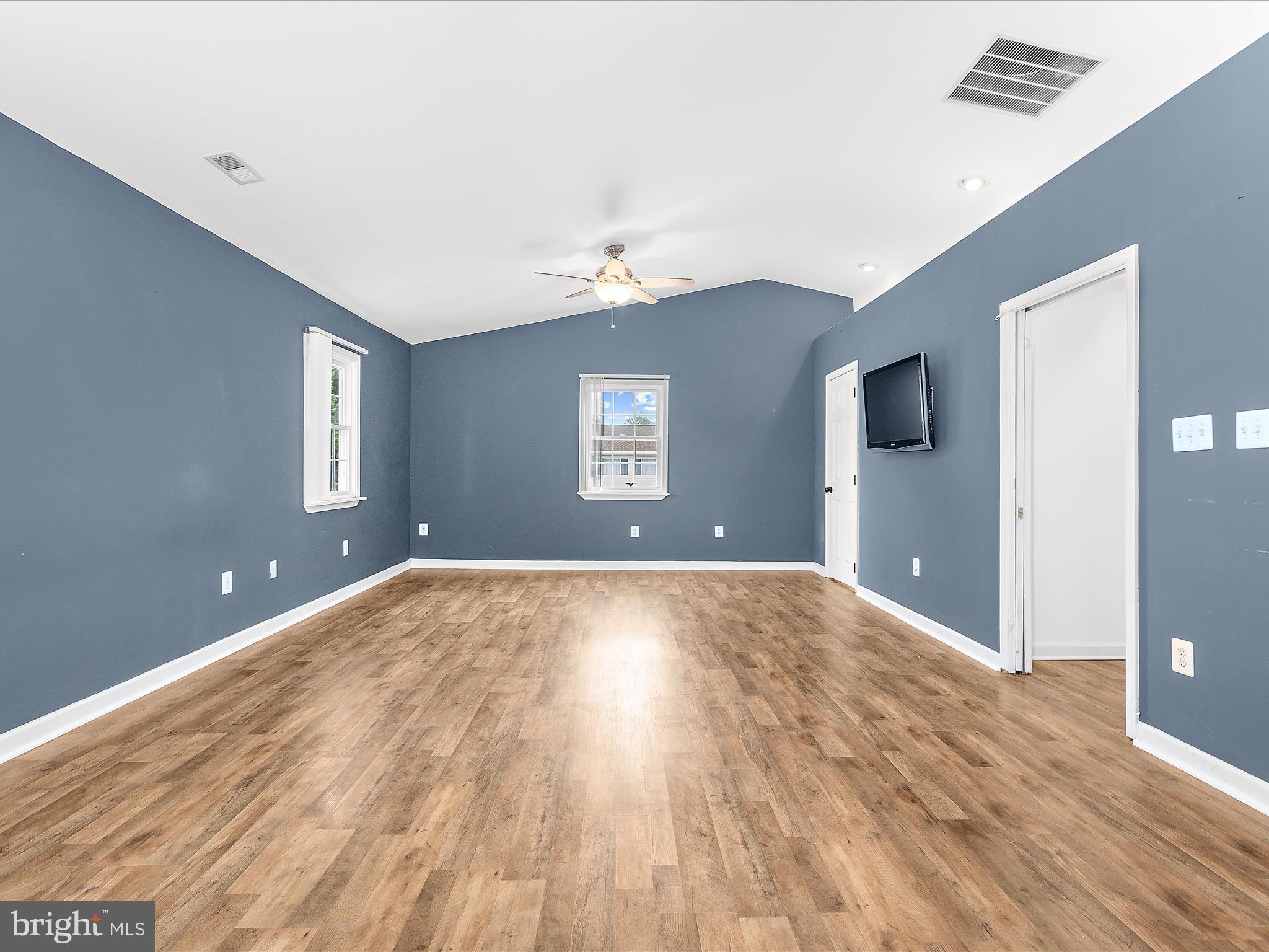 8475 Sexton Road Pasadena, MD 21122 - Photo 29 of 58 a view of a livingroom with wooden floor and a ceiling fan
