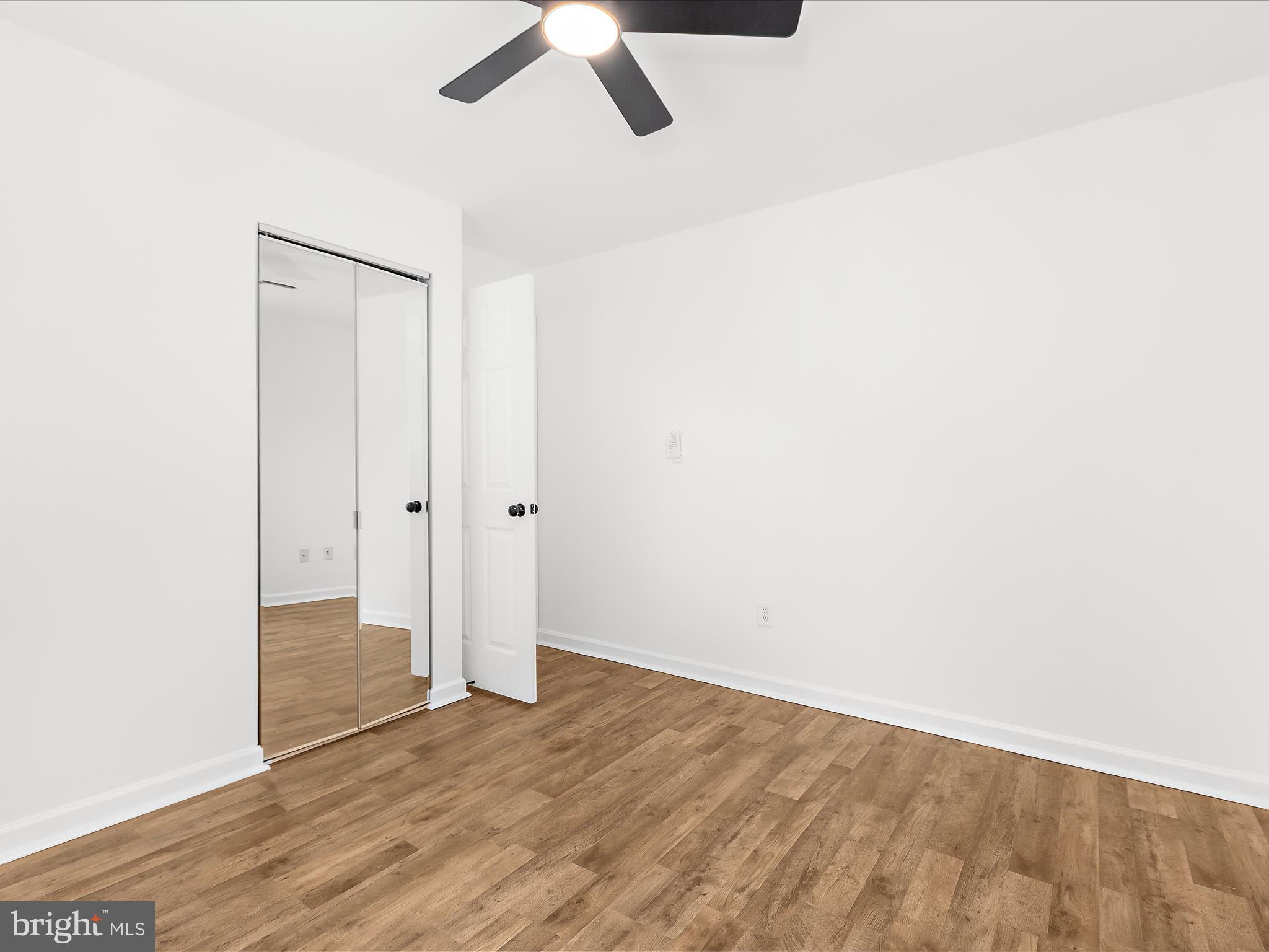 8475 Sexton Road Pasadena, MD 21122 - Photo 32 of 58 an empty room with wooden floor and windows