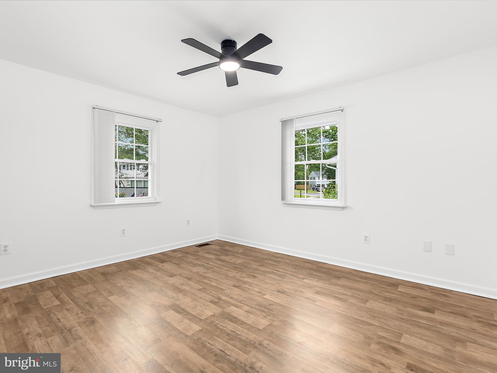 8475 Sexton Road Pasadena, MD 21122 - Photo 36 of 58 an empty room with wooden floor and windows