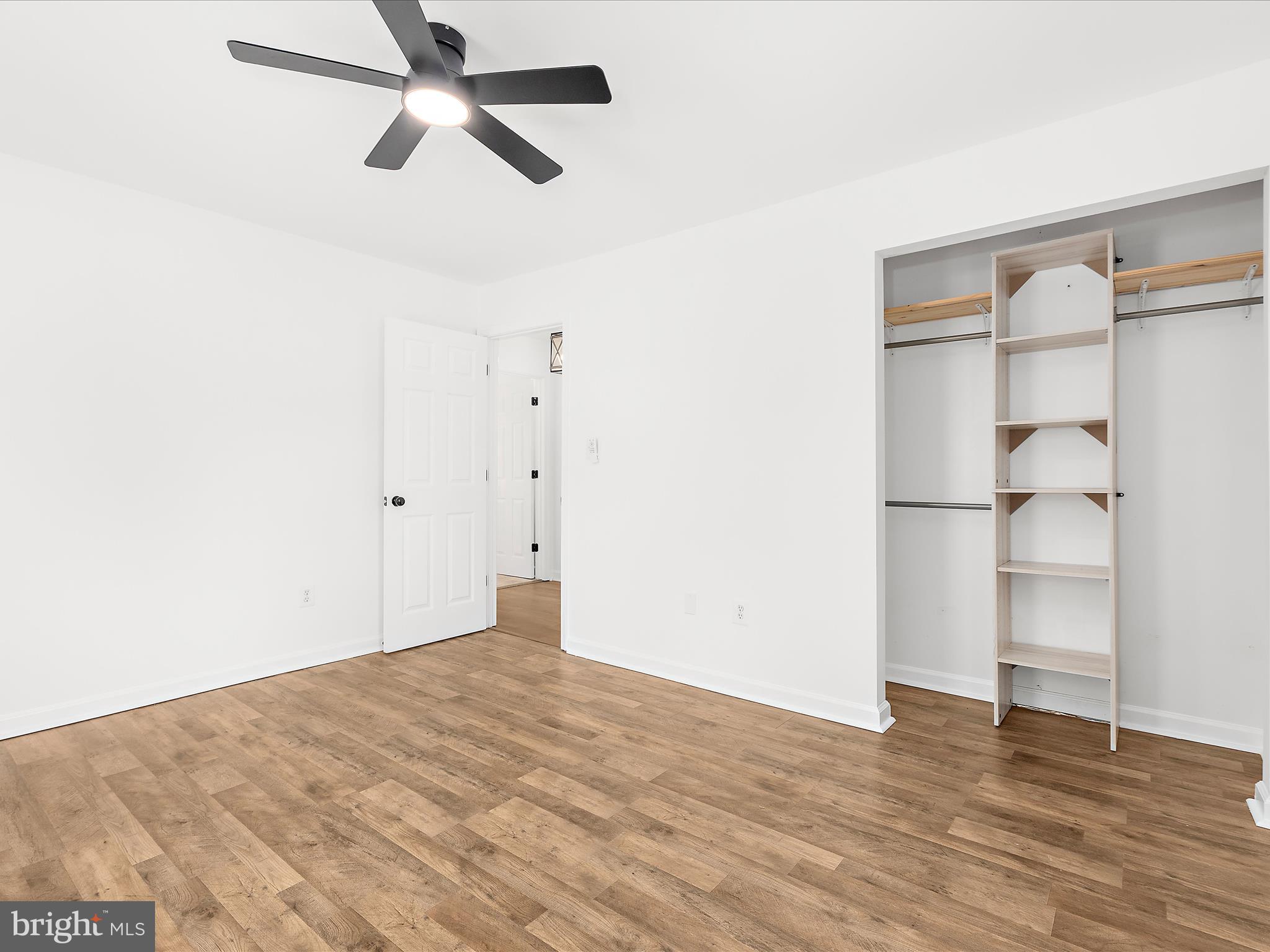 8475 Sexton Road Pasadena, MD 21122 - Photo 37 of 58 a view of empty room with wooden floor and fan